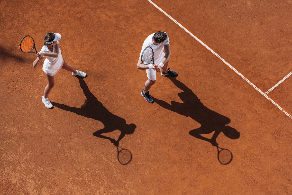 Tennis match on red clay courts at Trailside Tennis Club